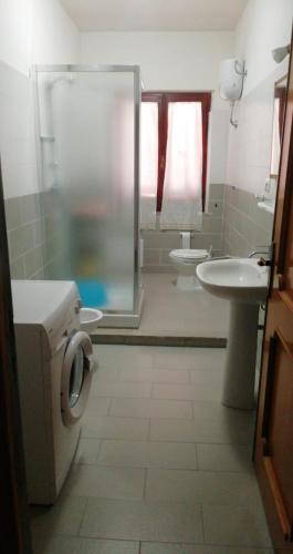 a bathroom with a shower and a sink and a toilet at Bithia Apartment in Chia