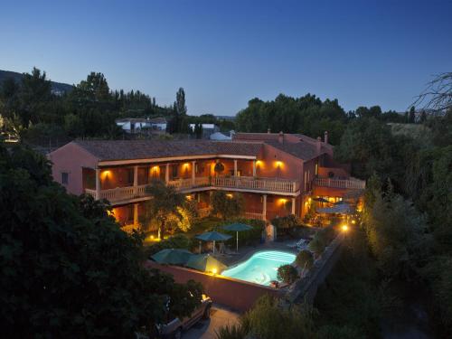 an aerial view of a house with a swimming pool at Hotel Rural Molino del Puente Ronda in Ronda