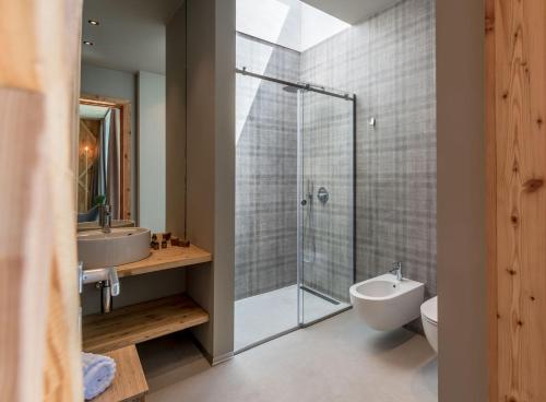 a bathroom with a shower and a toilet and a sink at Agritur La Dolce Mela - Adults Only in Vezzano