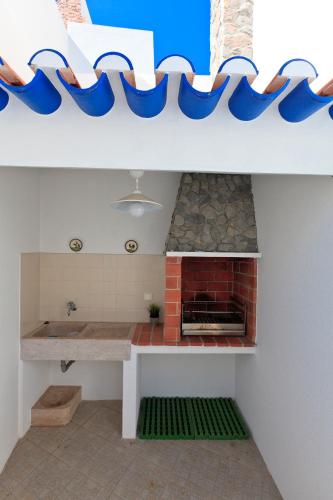 a kitchen with blue and white bowls on the wall at Like-home Boa Onda House-T4-Ericeira center in Ericeira