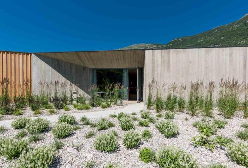 a building with a bunch of plants in front of it at Agritur La Dolce Mela - Adults Only in Vezzano