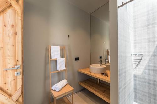 a bathroom with a sink and a mirror at Agritur La Dolce Mela - Adults Only in Vezzano