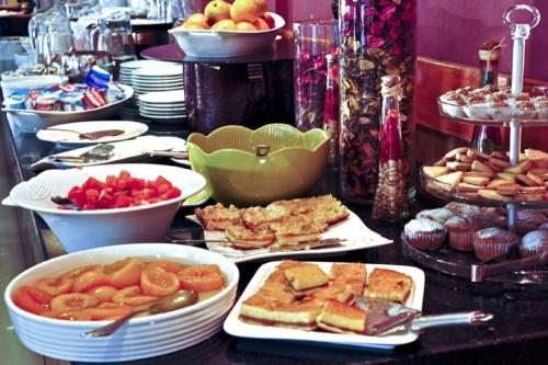a buffet with plates of food on a table at Hotel Diego de Almagro Valdivia in Valdivia
