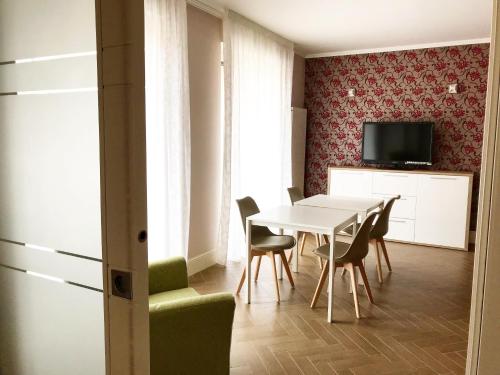 a dining room with a white table and chairs at B&B Civico22 in Torre Maggiore