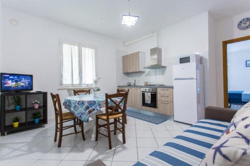 a kitchen and dining room with a table and chairs at Residence Kimba in Rimini
