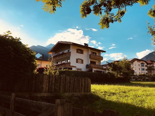 a house in the middle of a field with a fence at Gästehaus Schneeberger in Matrei in Osttirol