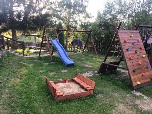 a playground with a slide and a slide at Apartmány Dolní Moravice in Dolní Moravice