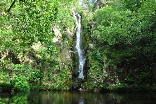 a waterfall in the middle of a body of water at Casa Rubal in Foz