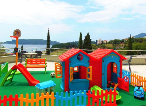 a playground with a play set and a slide at ApartHotel Belvedere Residence Becici Budva in Budva