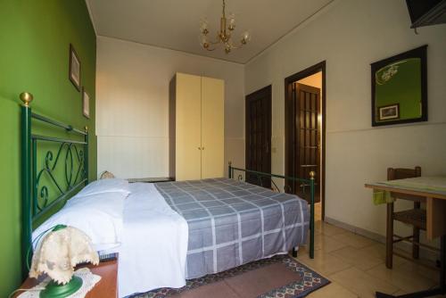 a bedroom with a bed in a room with a table at B&B Casa Paolo in Fiumefreddo di Sicilia