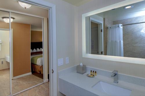 a bathroom with a sink, mirror, and shower at Best Western Plus Carpinteria Inn in Carpinteria