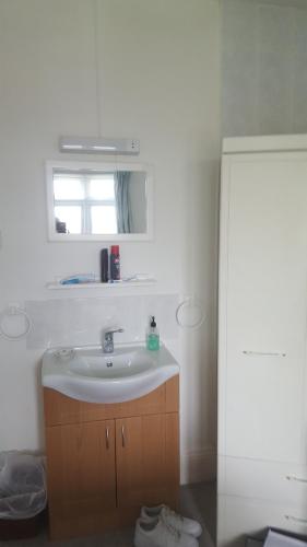 a bathroom with a sink and a window at Uppingham in Steyning