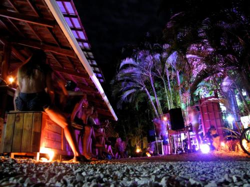 a group of people standing in front of a stage at night at Funky Monkey Lodge in Santa Teresa Beach