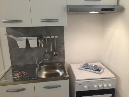 a small kitchen with a sink and a stove at I Villini in Pescara