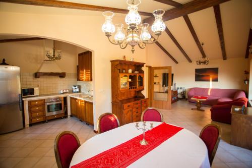 a kitchen and living room with a table and a dining room at Tunia in Strunjan