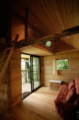 a room with a large glass door in a cabin at La Cabane aux Secrets - Au Milieu de Nulle Part in Outines