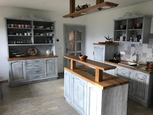 a kitchen with white cabinets and a counter top at Tourist farm Artisek in Štore