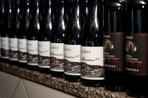 a row of bottles of wine on a shelf at Oasi Relais in Vico Equense