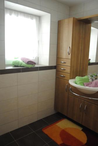 a bathroom with a sink and a mirror at "Opa Sepp" - Gartenwohnung in Niedernsill
