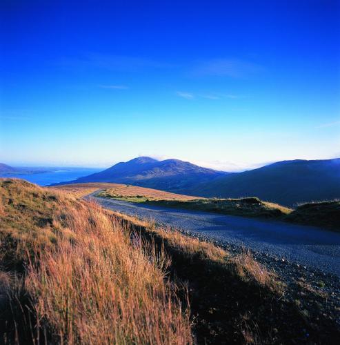 a river on a hill with mountains in the background at Ghan House in Carlingford