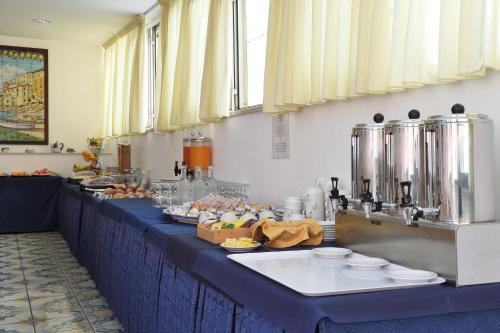 a buffet line with food on a table at Hotel7Bello in Minori