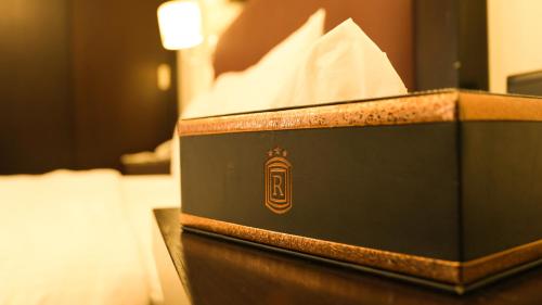a black box with a napkin and a tissue at Remas Hotel Suites - Al Khoudh, Seeb, Muscat in Seeb