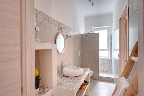a bathroom with a sink and a toilet in it at BUTTERFLY B&B in Lecce