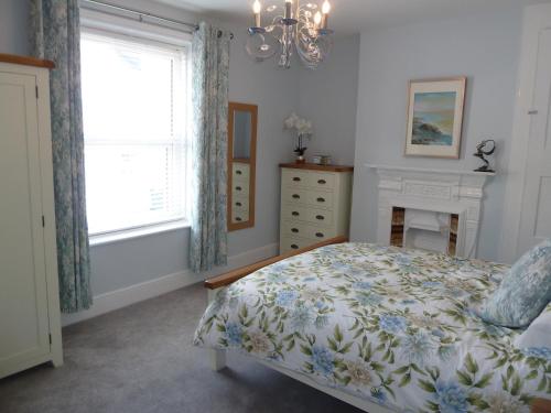 a bedroom with a bed and a fireplace and a window at Cornerstone in Portland