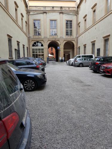 a parking lot with cars parked in front of a building at Hotel San Donato - Bologna centro in Bologna