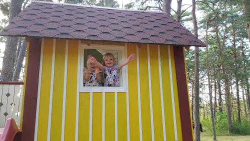 two little girls are in a play house at Männi Summerhouse in Kassari