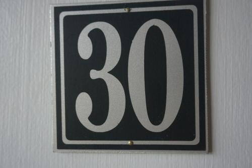 a black and white sign hanging on a wall at Northern Peaks Motor Inn in Gorham