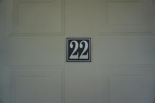 a sign on a door with the number on it at Northern Peaks Motor Inn in Gorham