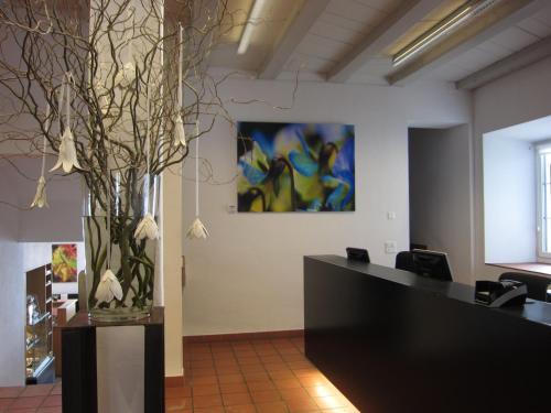 a office with a desk with a vase of flowers at Kloster Kappel in Kappel am Albis