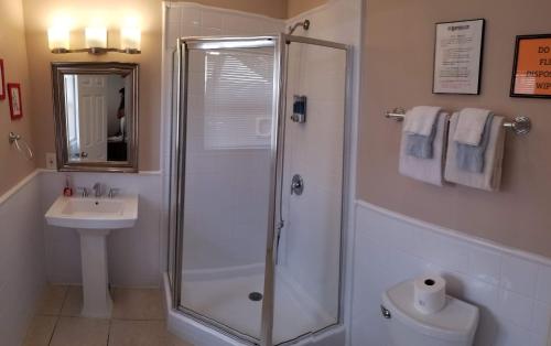 a bathroom with a shower and a toilet and a sink at INN LEATHER GUEST HOUSE-GAY MALE ONLY in Fort Lauderdale