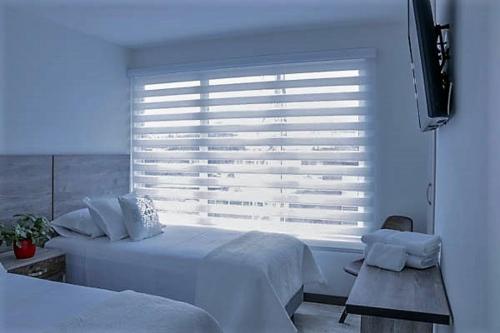 Un ou plusieurs lits dans un hébergement de l'établissement ARI Hotel