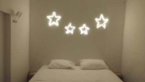 a room with a bed with four stars on the wall at Vintage Vieux-Port Apartment in Marseille