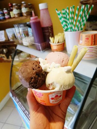 a person holding up a cup of ice cream at Lodge at The Old Barracks in Athenry
