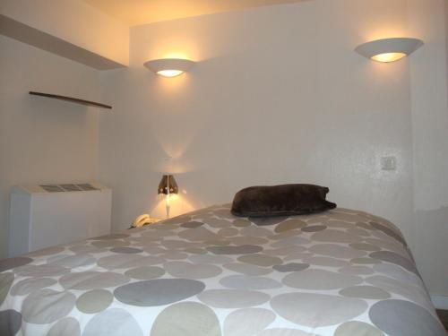 a bedroom with a bed with a pillow on it at Hôtel Restaurant de la Place in Saint-Jean-dʼAngély