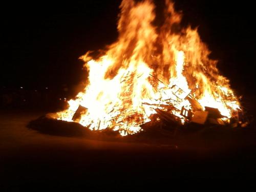 a large fire is burning in the dark at "LA TAVERNA" B&B in Airuno