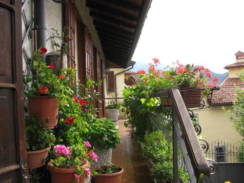 uma varanda com vasos de plantas ao lado de um edifício em "LA TAVERNA" B&B em Airuno