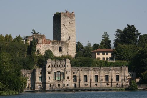 an old castle on the shore of a body of water at "LA TAVERNA" B&B in Airuno