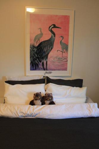 two dogs sitting on top of a bed at Visit Hautakylä in Hautakylä