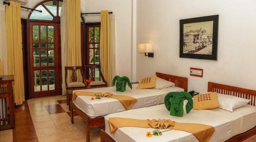 Postel nebo postele na pokoji v ubytování Senani Hotel