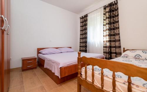 um quarto com 2 camas e uma janela em Tea Apartman em Neum