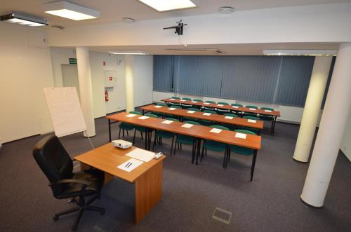 a large room with tables and chairs in it at Hotel Stawisko Klaudyn in Klaudyn
