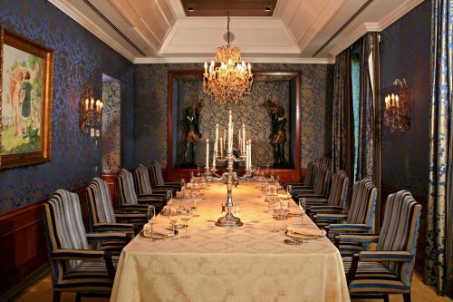 a long dining room with a long table and chairs at Grande Real Villa Itália Hotel & Spa in Cascais