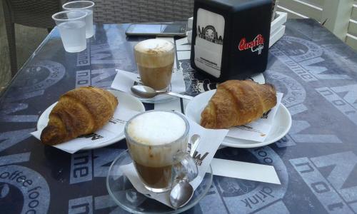 two cups of coffee and croissants on a table at Casa "Settima essenza" in Surbo