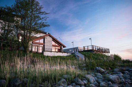 a house on the side of a hill with rocks at Koljunuki sadam "Veer" Lux accommodation in Ülgase