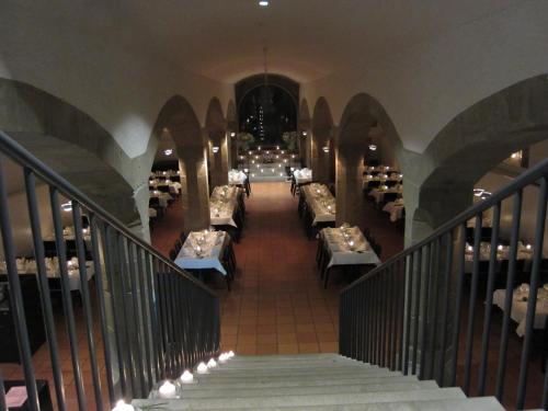 a hallway with tables and chairs in a restaurant at Kloster Kappel in Kappel am Albis