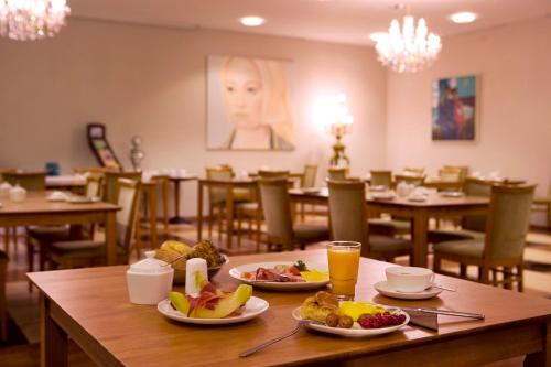 a table with two plates of food on top of it at ROSS Hotel in Stuttgart